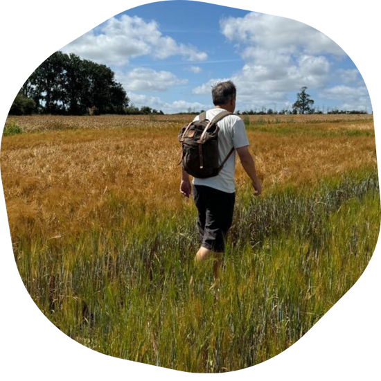 Andrew walking through a field