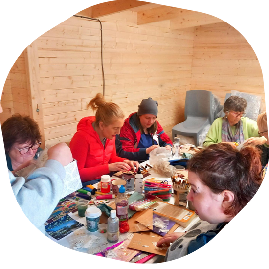 group of people sitting doing arts and crafts